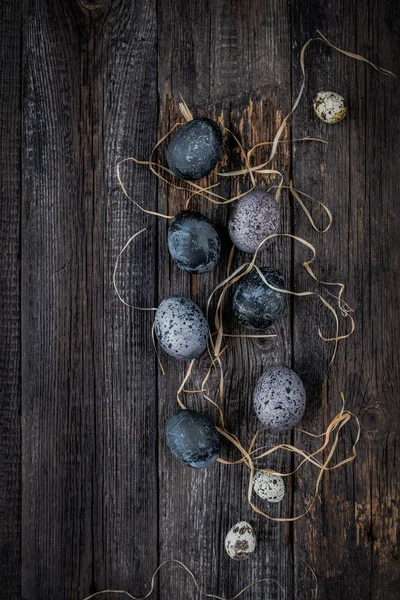 Pile Colored Quail Eggs Dry Grass Dark Wooden Background — Stock Photo, Image