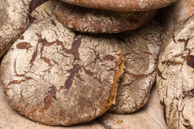 Fırın ekmek üreticileri - altın rustik huysuz somun ekmek ve siyah kara tahta zemin üzerine buns. Natürmort (üstten görünüm yukarıda, düz yatıyordu yakalanan).