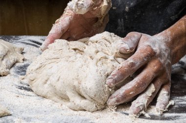 Erkek eller hamur yoğurur un serpilmiş, yakın plan.