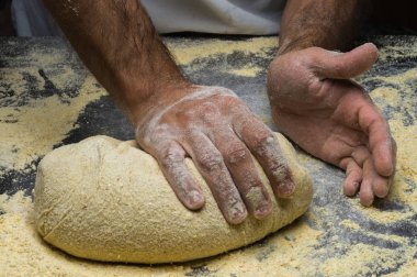 Erkek eller hamur yoğurur un serpilmiş, yakın plan.