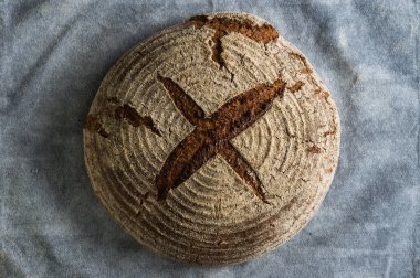 Fırın ekmek üreticileri - altın rustik huysuz somun ekmek ve siyah kara tahta zemin üzerine buns. Natürmort (üstten görünüm yukarıda, düz yatıyordu yakalanan).