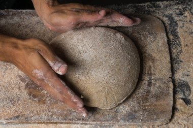 Fırıncı ekmek pişiriyor. Adam hamura un döker. Ekmek yapan adam