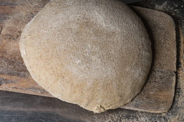 Baker cooking bread. Man slaps flour over the dough. Man Making bread