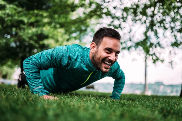 Young Man Laughing While Doing Push — Stock Photo, Image