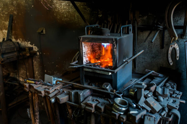 close-up photo of Blacksmith workshop with fire.