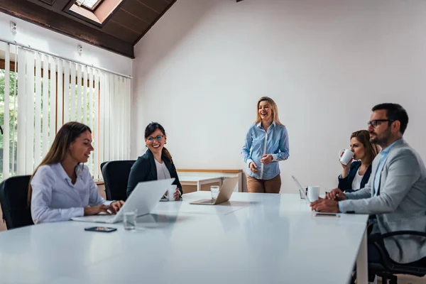 Woman giving presentation in conference or meeting.