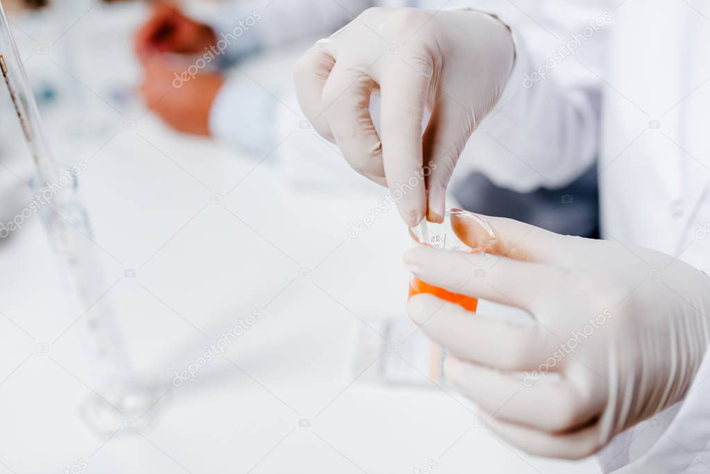 Close-up image of lab technicians hands working on a sample.