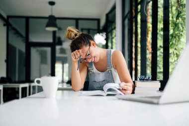 Gülümseyen kız Koleji'nde otururken ödev.