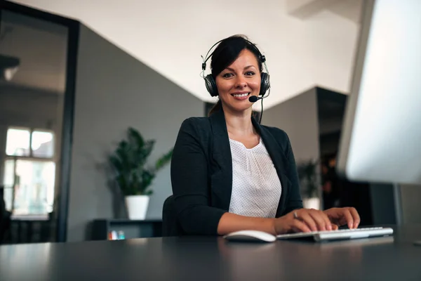 Customer service help desk. Young woman in headset