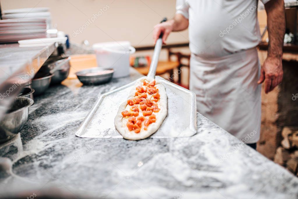 close-up view of chef preparing macedonian pizza.