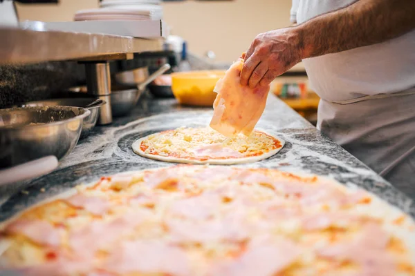 Delicious pizza preparation. Close-up.