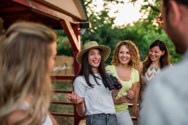 Group of friends laughing while having a vacation in nature. clipart