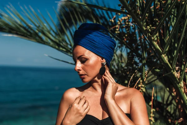 Summer portrait of an elegant woman by the sea.