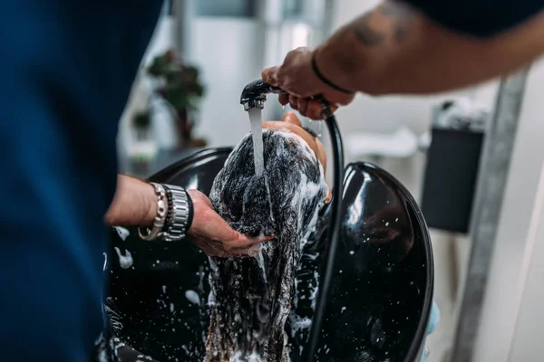 Hair washing at a hairdressing salon. Close-up.