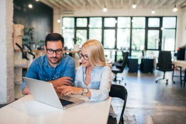 İki güzel genç tasarımcılar birlikte modern ortak çalışma ofisinde çalışan.