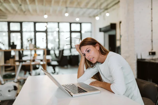 stock image Young woman working in bright co-working office.