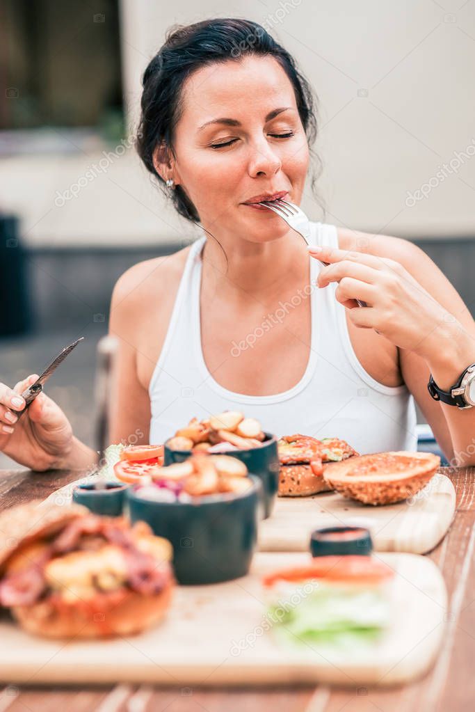 Young woman eating delicious meal.