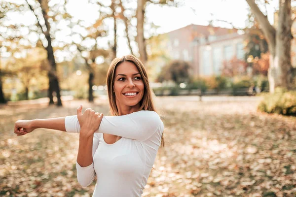 Smiling Young Woman Stretching Arms Autumn Park — Stock Photo, Image