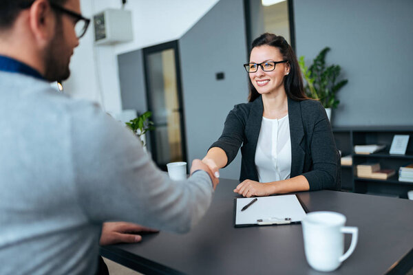 Business partners shaking hands after agreement.