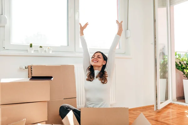 Moving New Home Happy Woman Arms Raised Sitting Floor Carton — 图库照片