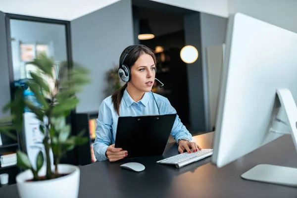 Concentrated Young Women Working Support Center Stock Picture