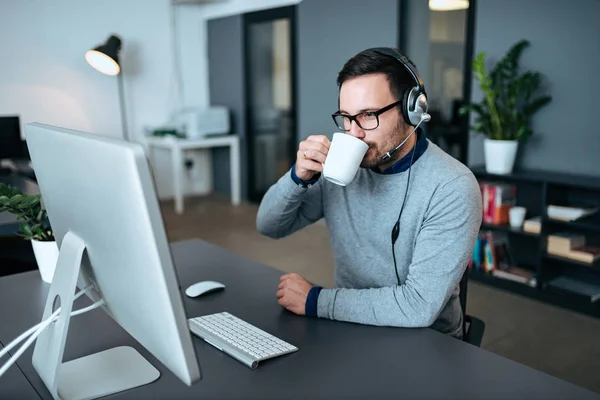 Attractive Support Center Agent Taking Coffee Break Call Stock Picture