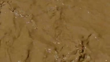Kirli, çamurlu ve sarı su akışı. Çevre kirliliği. Selden sonra değil temiz bir nehir.