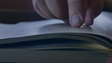 Bir adam kitap okur ve sayfaları karıştırır. Kütüphanede kitap okuyor. Bilimsel materyaller üzerine çalışıyorum. Arşive bakıyorum..
