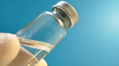 Doktor bir enjeksiyon şırınga hazırlanıyor. İlaç kullanıyor. Aşı. Enfeksiyon. Bölgede karantina.