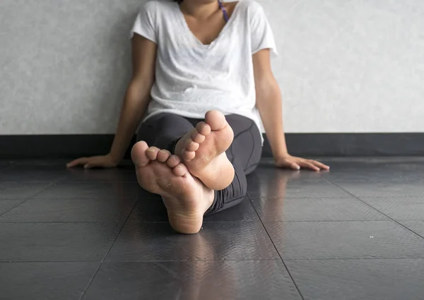 Young woman doing yoga taking a break sitting cross legged