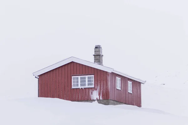 Winter log cabins in the snow in Norway surrounded by a frosty landscape