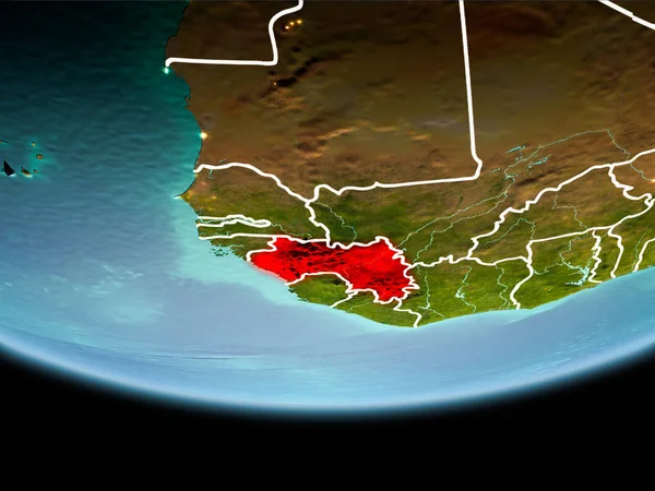 Country of Guinea in red on planet Earth in the evening with visible border lines and city lights. 3D illustration. Elements of this image furnished by NASA.