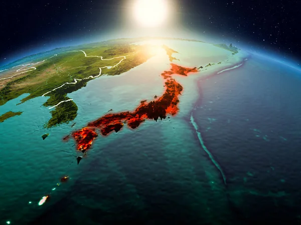 Sunrise above Japan highlighted in red on model of planet Earth in space with visible country borders. 3D illustration. Elements of this image furnished by NASA.