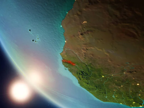 Satellite view of Gambia highlighted in red on planet Earth with visible country borders during sunset. 3D illustration. Elements of this image furnished by NASA.