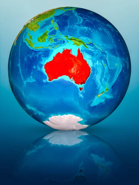 Australia in red on model of planet Earth on reflective blue surface. 3D illustration. Elements of this image furnished by NASA.