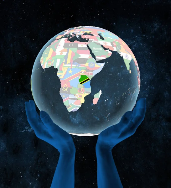 Tanzania on translucent political globe in hands in space. 3D illustration.