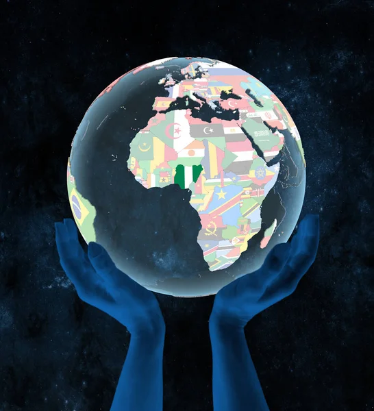 Nigeria on translucent political globe in hands in space. 3D illustration.