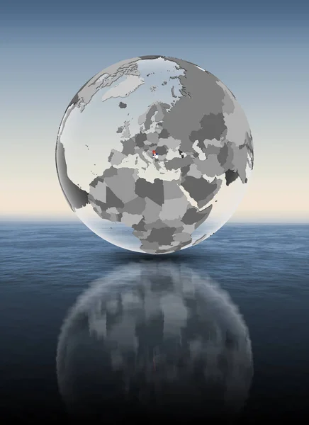 Serbia with flag on translucent globe above water. 3D illustration.