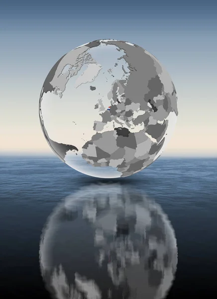 荷兰与旗子在半透明的地球在水之上 — 图库照片