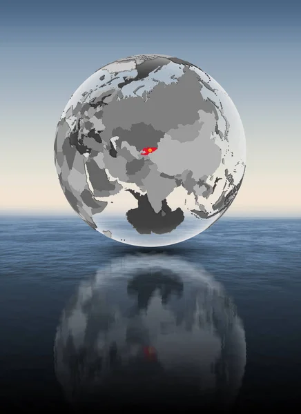 吉尔吉斯斯坦在水面上半透明的地球仪上有旗帜 — 图库照片