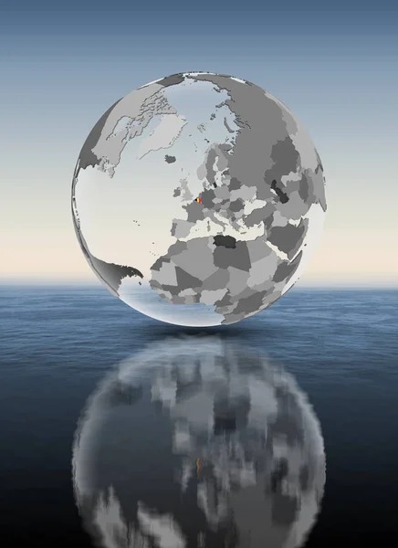 比利时与旗子在半透明的地球在水之上 — 图库照片