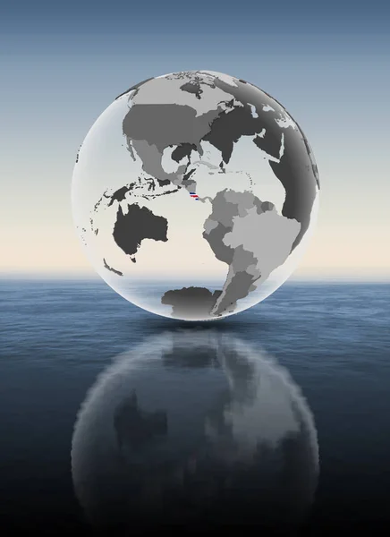 哥斯达黎加在水面上半透明的地球仪上有旗帜 — 图库照片