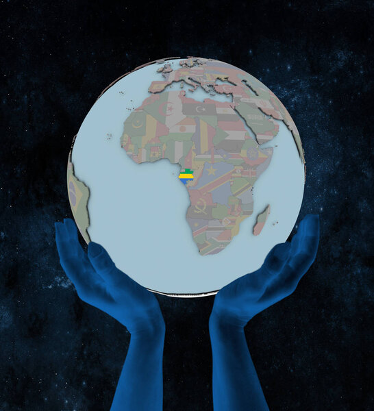 Gabon with flag on globe in hands in space. 3D illustration.