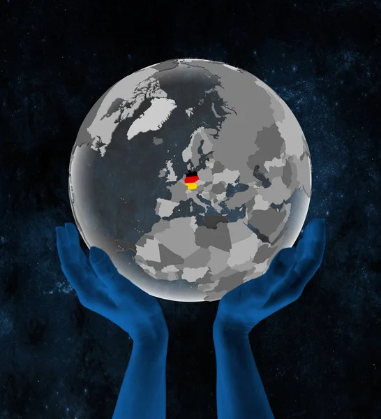 Germany With flag on translucent globe in hands in space. 3D illustration.