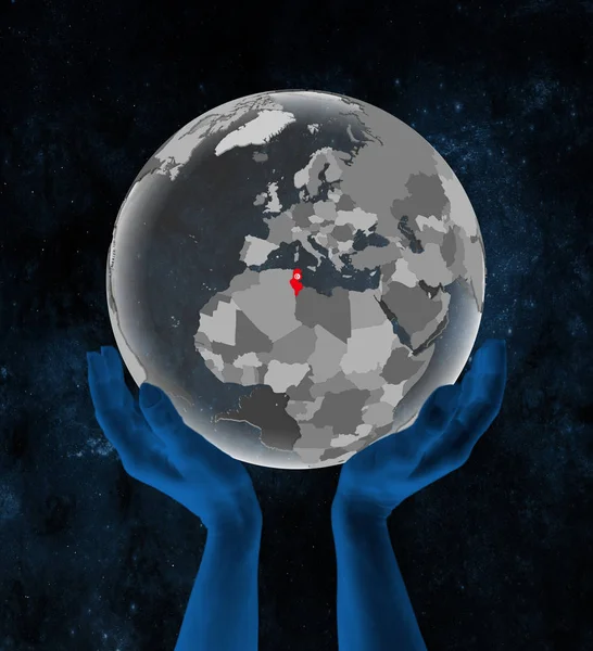 突尼斯与旗子在半透明的地球在手在空间 — 图库照片