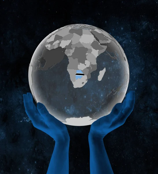 Botswana With flag on translucent globe in hands in space. 3D illustration.