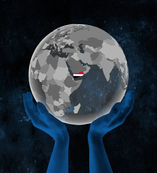 Yemen With flag on translucent globe in hands in space. 3D illustration.