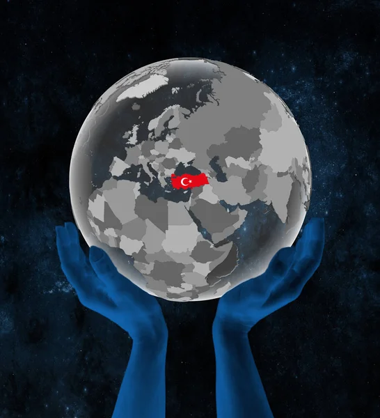 Turkey With flag on translucent globe in hands in space. 3D illustration.