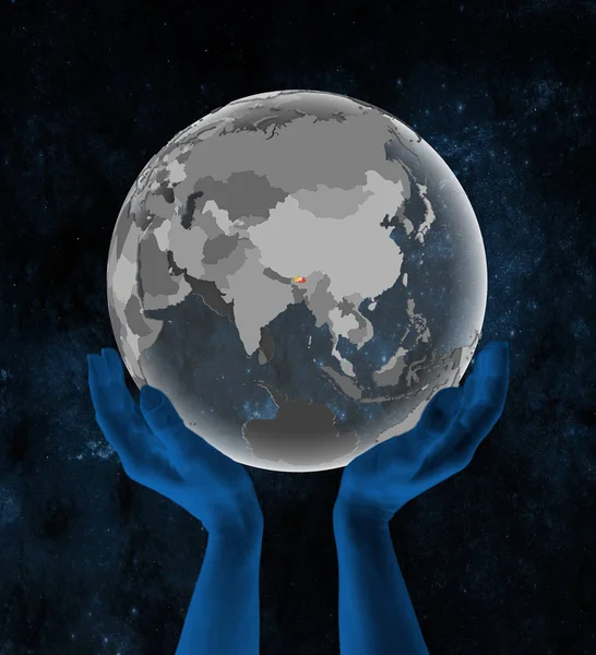 Bhutan With flag on translucent globe in hands in space. 3D illustration.