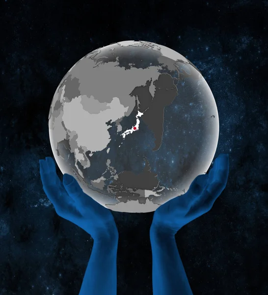 Japan With flag on translucent globe in hands in space. 3D illustration.